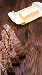 Sliced rye bread,chicken eggs,butter on an old wooden table,close - up