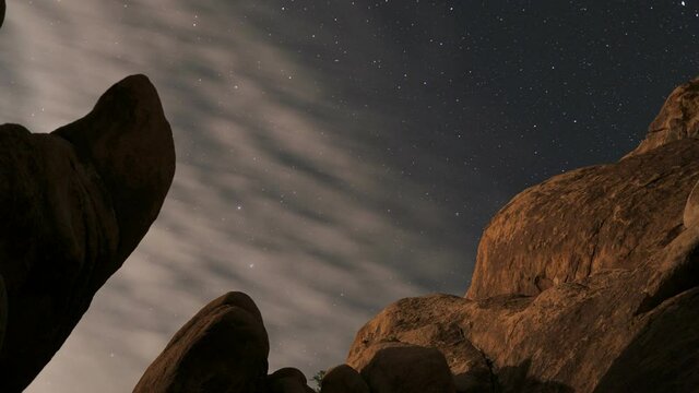 Star time lapse below amazing rock formations