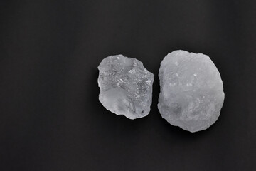 White alum cubes on black background, concept for applying underarms to reduce body odor and swing the cloudy water into the sediment.