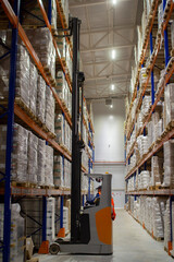 Loader in warehouses. Stacks of boxes in an industrial warehouse.