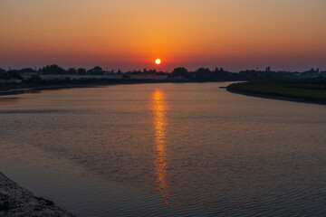 Fototapeta na wymiar Colorful sunset on the river