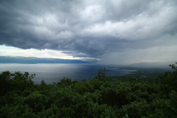 Fototapeta na wymiar Sun and rain on lake Tornetrask, seen from mount Nuolja. 