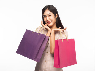 Portrait of smiling beautiful asian woman wearing dress and holding shopping bags isolated on white background.