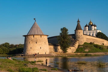 Pskov Kremlin view from river Pskova creek. Towers, wall and Trinity cathedral on background.