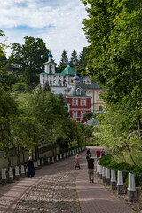 Fototapeta premium View form thr Bloody Path on Uspenskaya square with Sacristy, belfry, Uspensky (Assumption) cathedral in the Dormition Pskovo-Pechersky Monastery