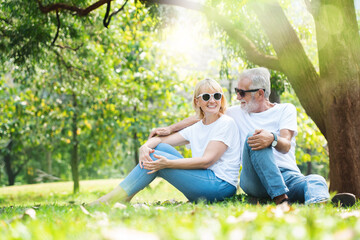Fototapeta premium Portrait Senior family happy in the garden of summer. Lifestyle elderly Caucasian couple. Old man and the women come for a picnic With beautiful nature. Concept Health care insurance