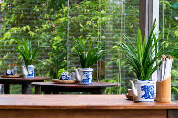 Vietnamese traditional restaurant style decoration with green leaf and teapot background bamboo...