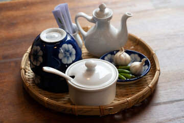 Vietnamese traditional restaurant style decoration with green leaf and teapot background bamboo lamp 