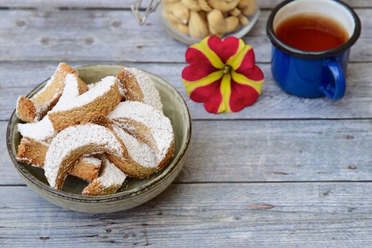 kue Putri salju (snow princess cookies or snow white cookies) is cute crescent shaped vanilla cookie with a crumbly, melt-in-your-mouth texture and covered in powdered sugar. selected focus 
