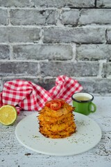 Hash browns or potato pancakes or Swiss Rösti garnish with cherry tomato and parsley