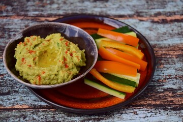 Avocado hummus with zucchini bell pepper veggie sticks