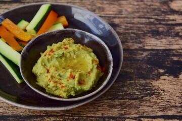 Avocado hummus with zucchini bell pepper veggie sticks