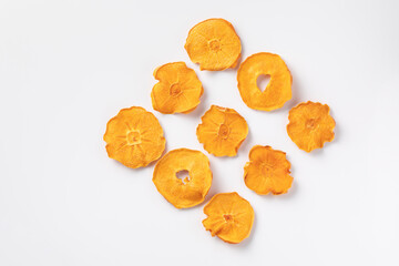 slices of dried persimmon on a white background. dried fruits. eco. top view.