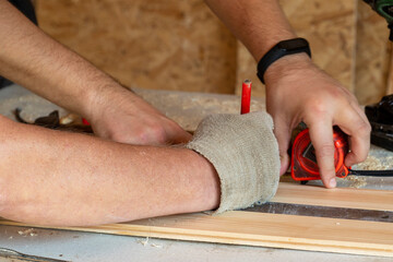 hands of workers mark materials with a pencil, close-up. People at work