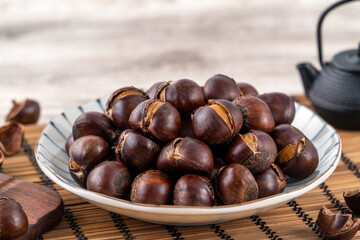 Close up of delicious roasted chestnuts with oil for eating.