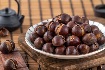 Close up of delicious roasted chestnuts with oil for eating.