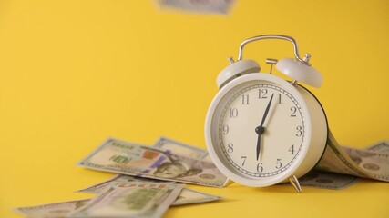 Alarm clock and falling dollars on yellow background. Time money concept - Powered by Adobe