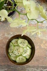 Obraz na płótnie Canvas Asian cucumber salad with black sesame seeds and chili flakes. top view