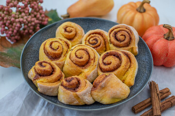 sweet home made autumn cinnamon rolls with pumpkin