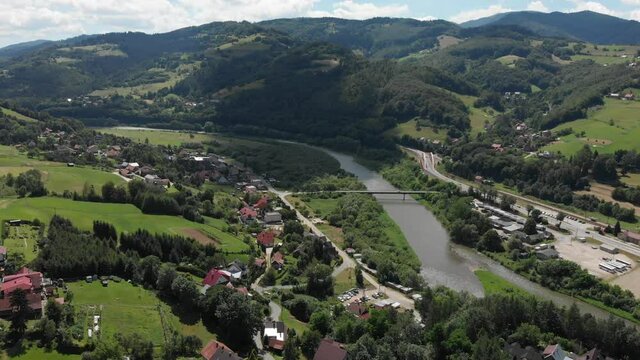 Village Sucha Struga and Poprad River in summer. Beskid Sadecki Mountains, Poland.