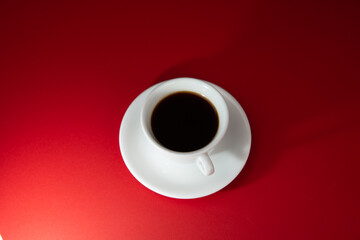 cup of coffee on the red background. Americano.