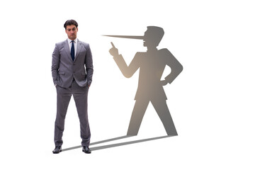 Concept of businessman liar with his shadow