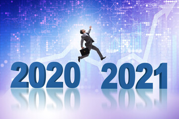 Businessman jumping from the year 2020 to 2021