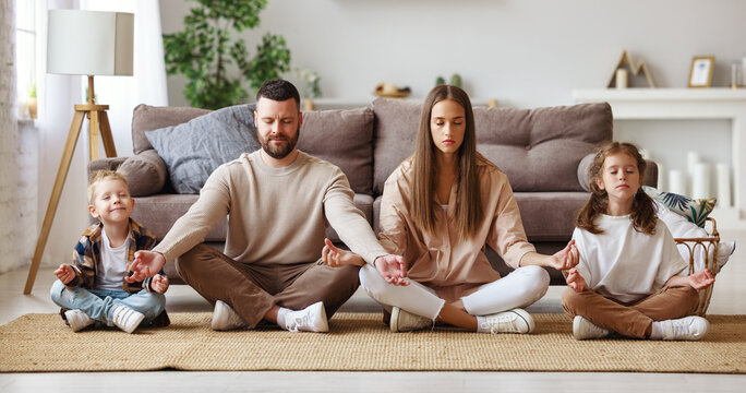 happy healthy family meditates at home.