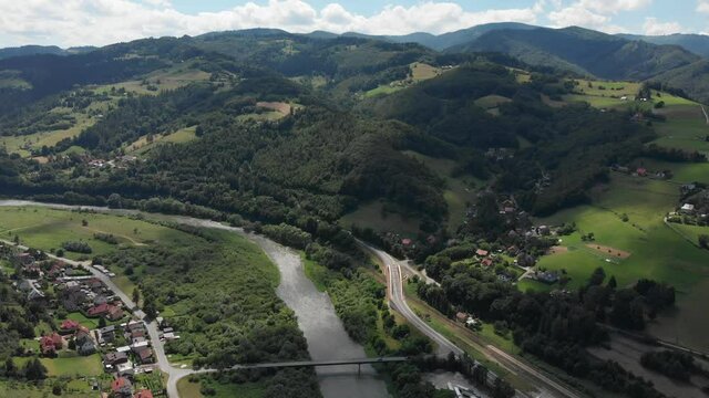 Poprad river, village Rytro and Sucha Struga in summer at Beskid Sadecki Mountains background