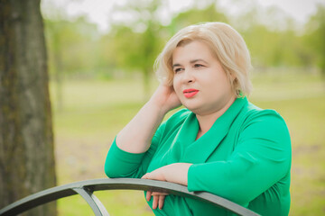 Portrait of American plus size businesswoman in green dress, citizen lifestyle, concept of women's life