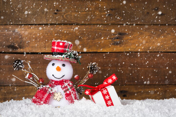 Happy snowman against wooden background with copy-space, as a concept for Merry Christmas and happy...