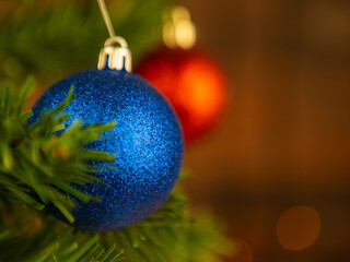 Blue Christmas ball on the tree. Blurred background.
