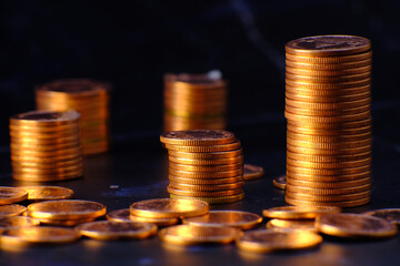Stack of golden coins on black background and advertising coins of finance and banking,increasing columns of gold coins on table