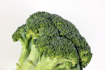 whole green broccoli closeup on white background