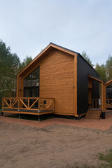 Barnhouse style house. House in the bosom of nature. Greenery and trees.