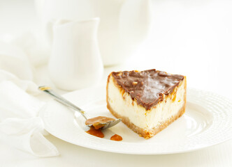 Slice of cheesecake with caramel and nuts. Selective focus.