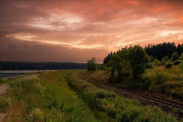 a landscape with railway line in the sunset
