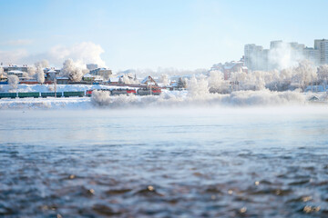 Winter landscape of frosty trees, white snow in city park. Trees in hoarfrost. Seasons, climate change, ecology, environment. Extremely cold winter