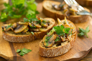 Bruschetta with fried mushrooms with onions and parsley.