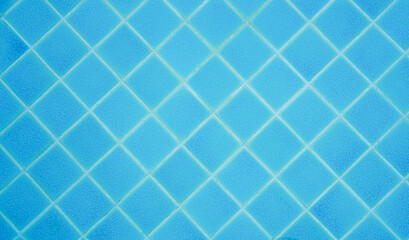 Top view of pool wall tiled with blue ceramic background