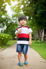 Fototapeta premium Playful Asian young boy enjoy playing at the park.
