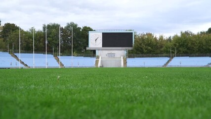 Empty Football Stadium With Scoreboard Before Match Or During Coronavirus Pandemic - Powered by Adobe