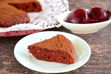Beetroot chocolate cake with cacao powder on wooden background