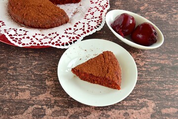 Beetroot chocolate cake with cacao powder on wooden background