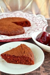 Beetroot chocolate cake with cacao powder on wooden background