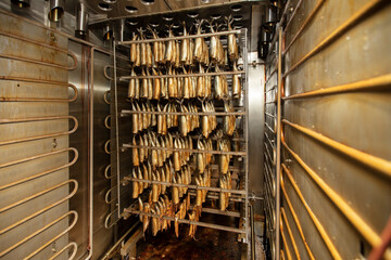 Industrial smoking of fish. Mackerel in a smoking oven. © Светлана Лазаренко