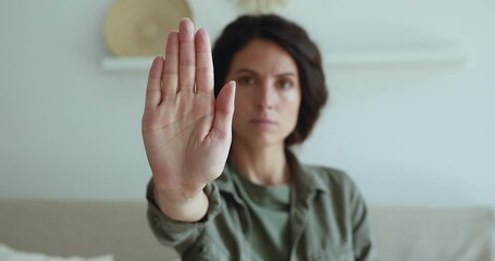 Serious girl stretch out her palm to camera says stop abortion, close up. Community participant anti domestic violence, racism racial discrimination. Struggle for women rights, social problems concept