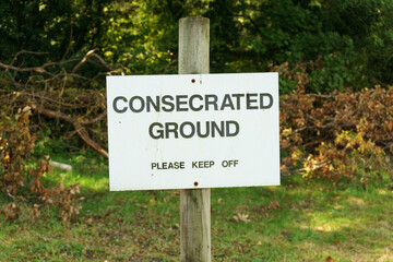 Consecrated ground sign at a cemetery implying it has been declared sacred or holy, and is can be used for Christian burial