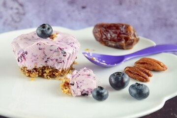 Obraz na płótnie Canvas Vegan mini blueberry cheesecake ice cup with pecan date crust
