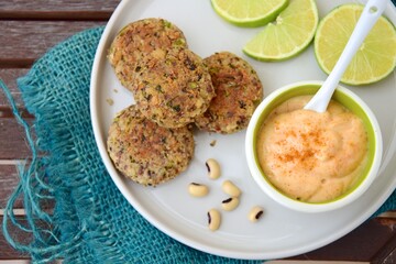 Delicious quinoa jalapeño bean burger patties with chili mayonnaise dip garnish with lime